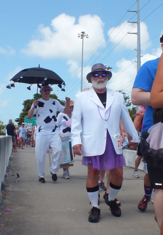 two men wearing costumes walking down the street