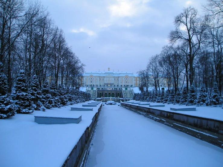 snowy landscape with park bench in front of buildings