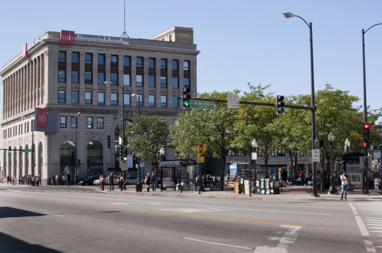 the intersection with traffic lights, pedestrians and cars