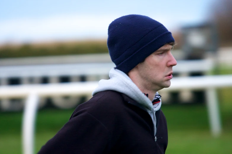 a close up view of a man wearing a beanie