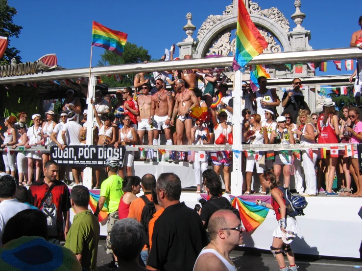 a group of gay people are at a gay pride float