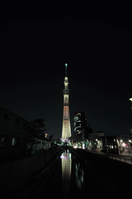 tall tower that is lit up on a dark night