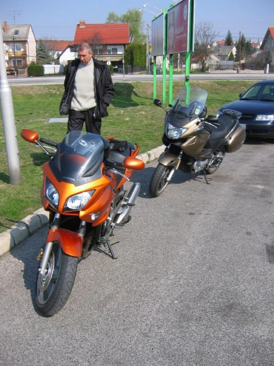 a man stands next to a parked motorcycle