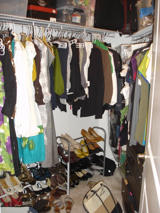 there is a closet with several clothes and footwear