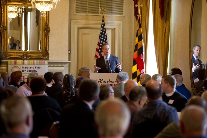 a man standing at a podium while speaking