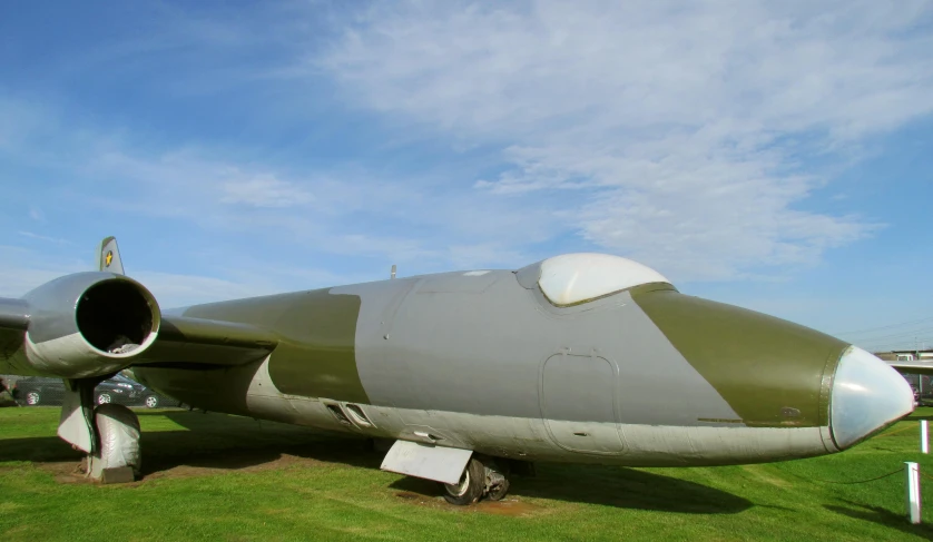 an old military plane sitting on display at an airport