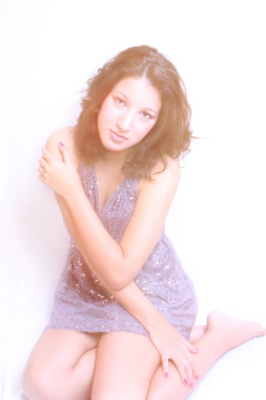 a young woman sits on the ground wearing her panties