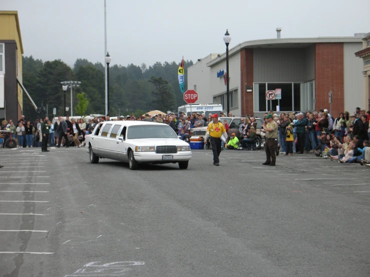 people watching police cars in a parking lot