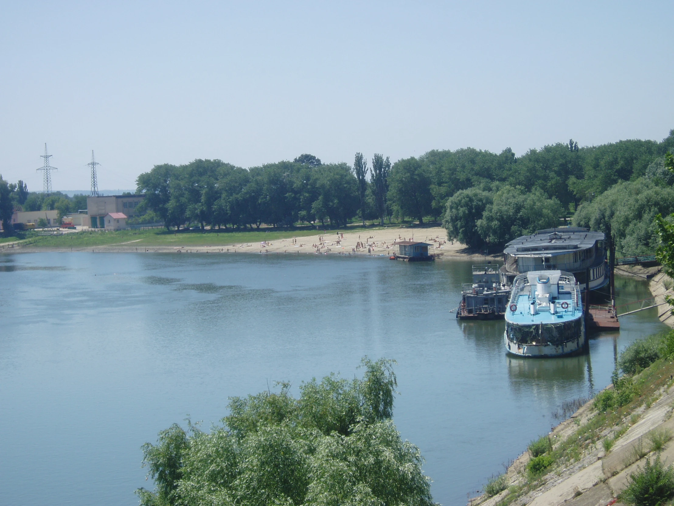 there are boats parked along the water by the shore