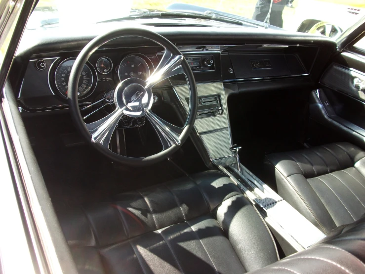 the interior of a car, with steering wheel and dashboard