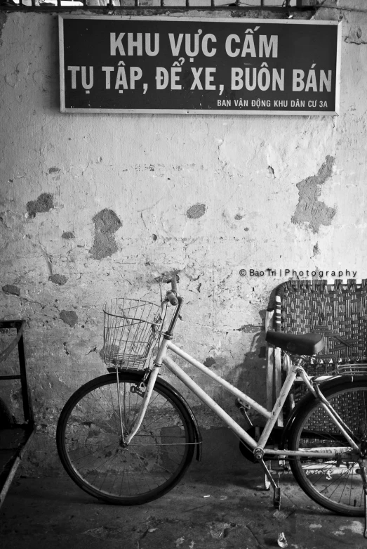 the bike is parked next to the sign on the building