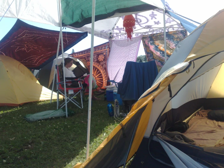 a group of tents are lined up together with clothes