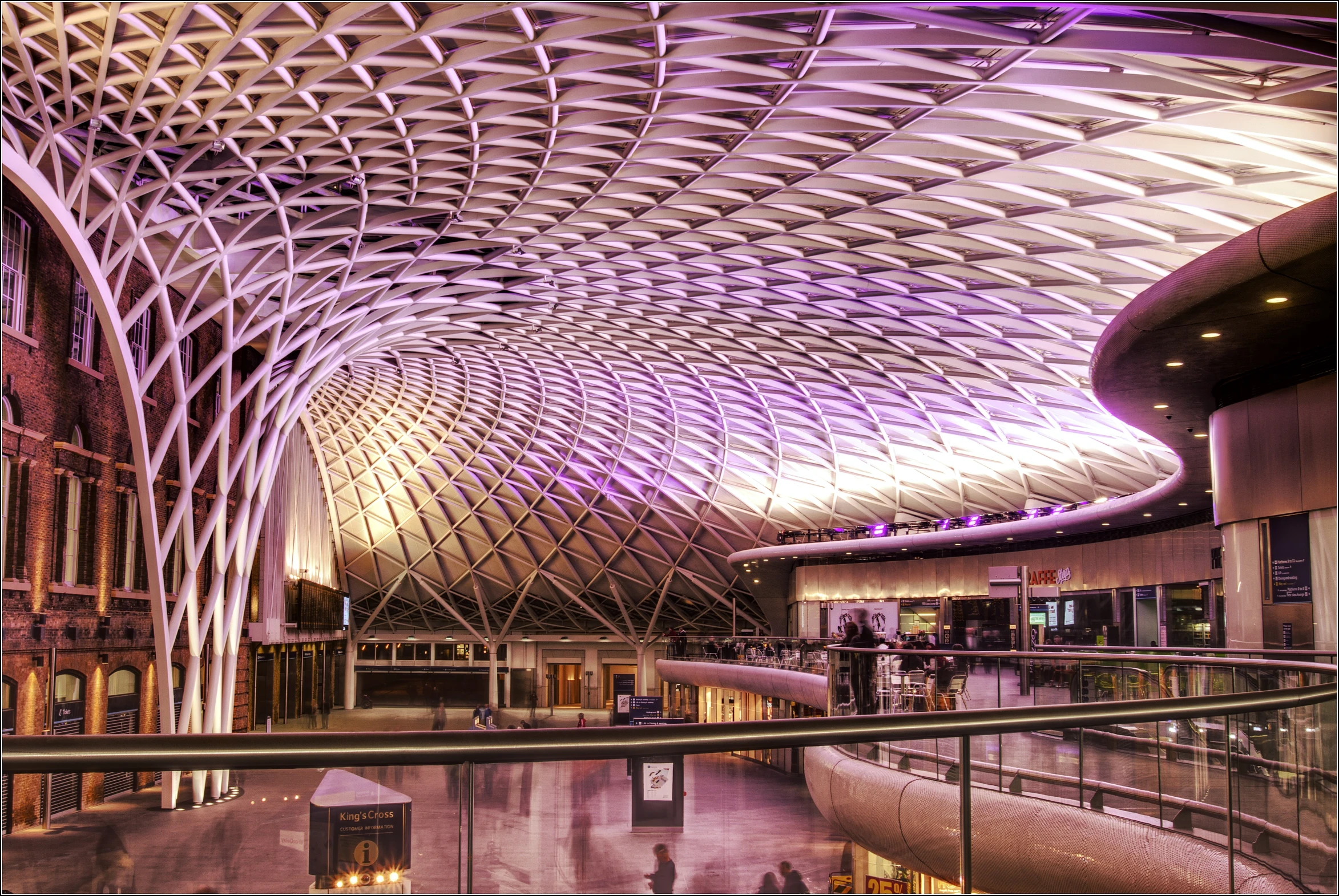 the roof is lit up purple in the evening