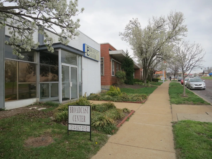 two signs outside of a store in a neighborhood