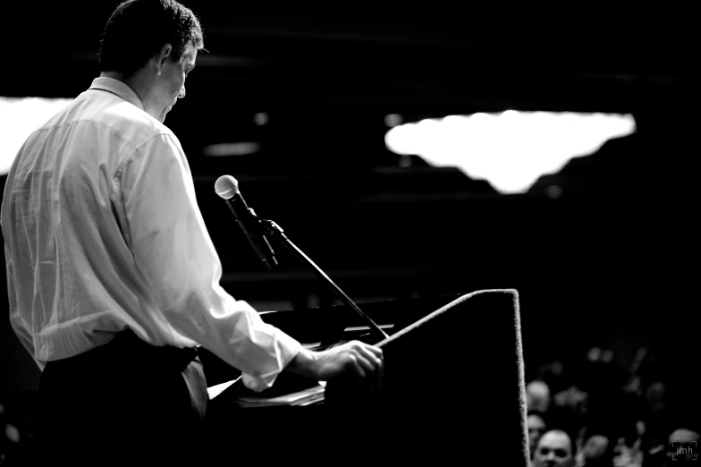 a man stands at a podium giving a speech