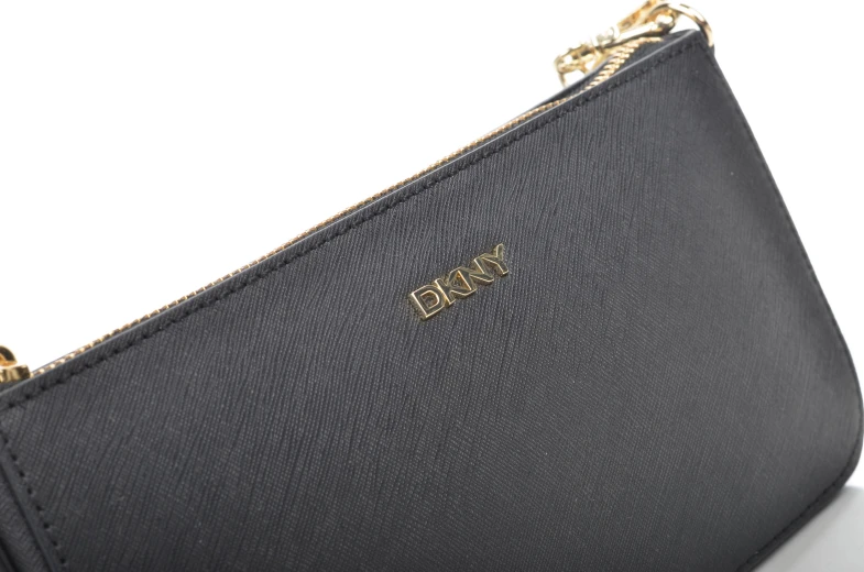 a close up of a black purse on a white surface