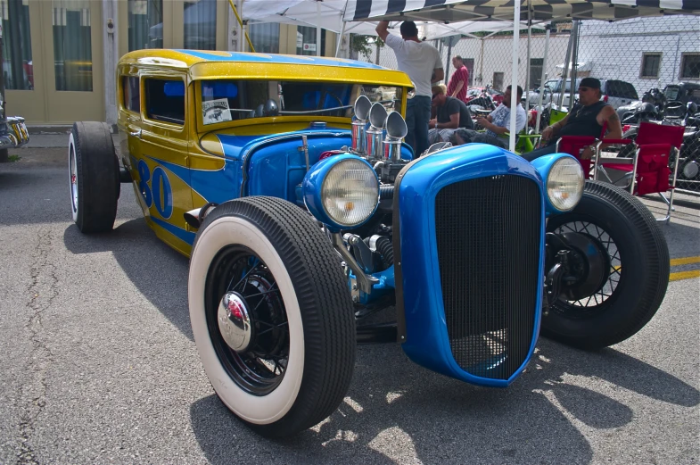 a vintage blue car parked in a parking lot