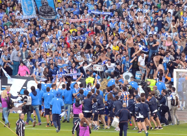 a group of soccer players walk across the field