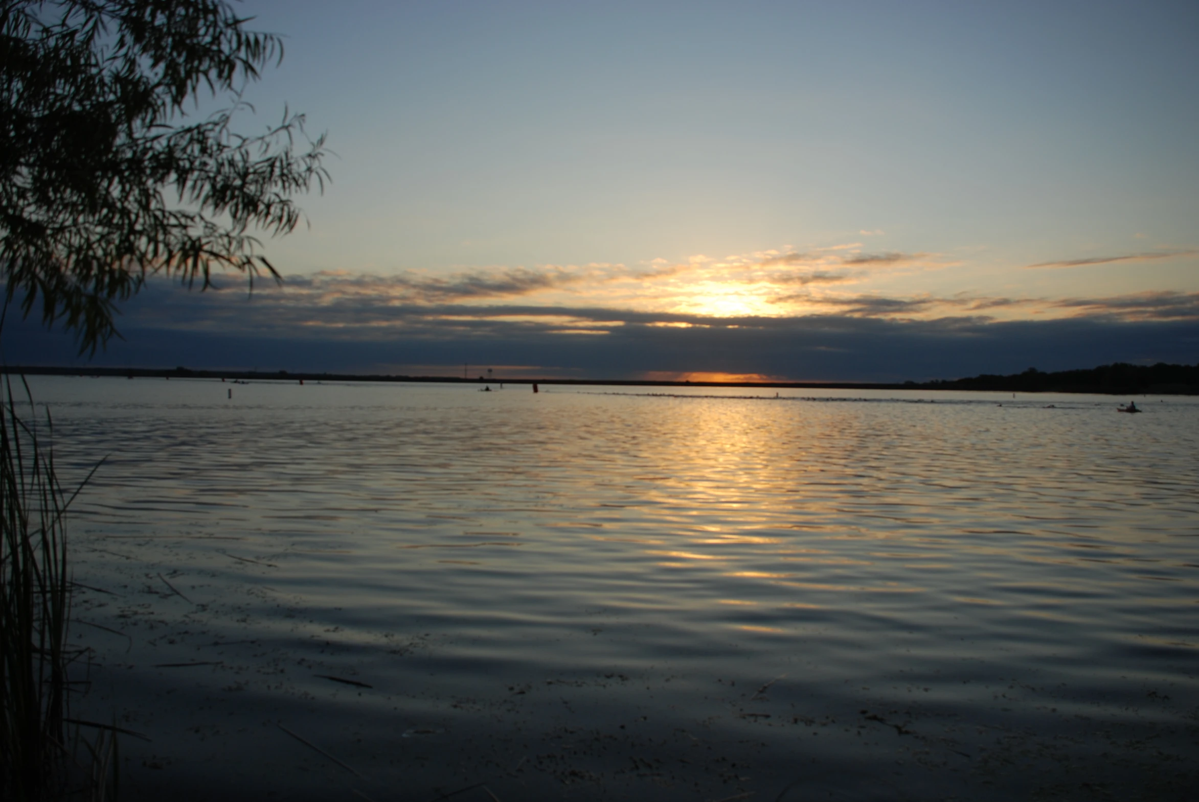 the sun setting in the middle of water