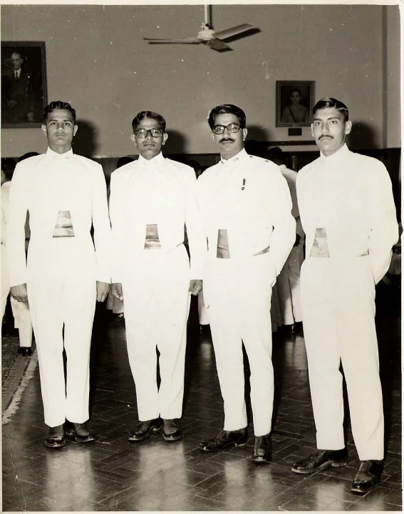 a group of men standing in formal wear