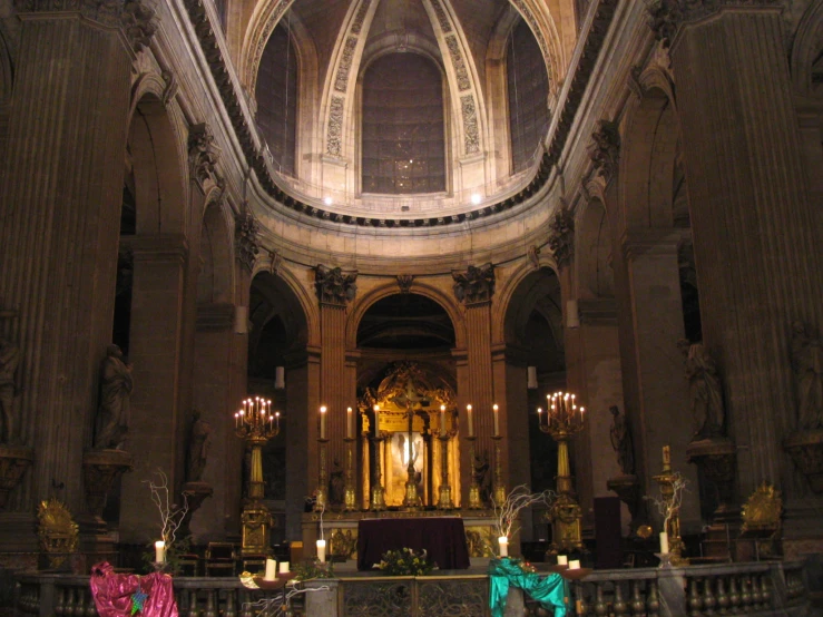 a church with ornate arches and pillars, decorated in gold and purple