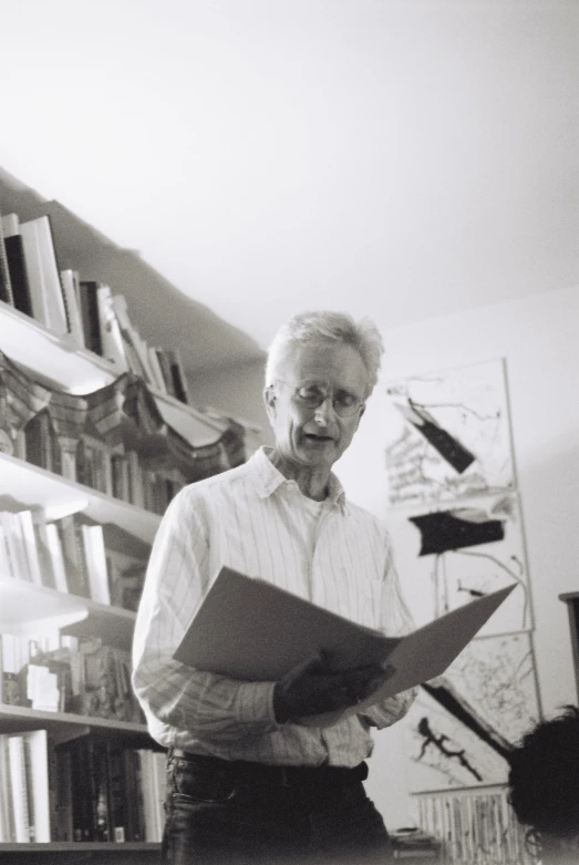 a black and white po of a man reading a book