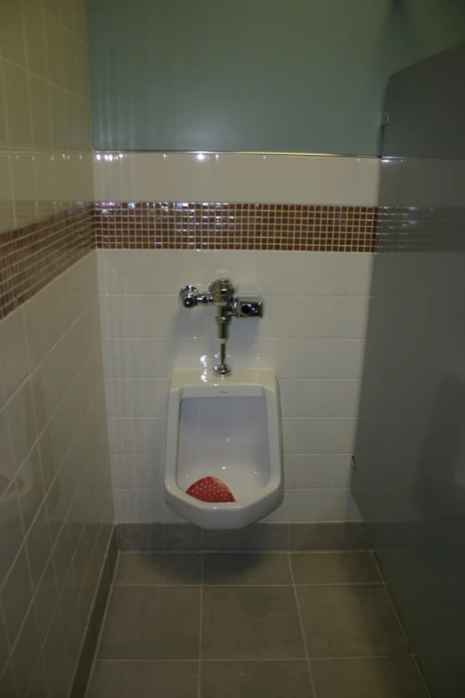 a urinal and toilet bowl in a public restroom