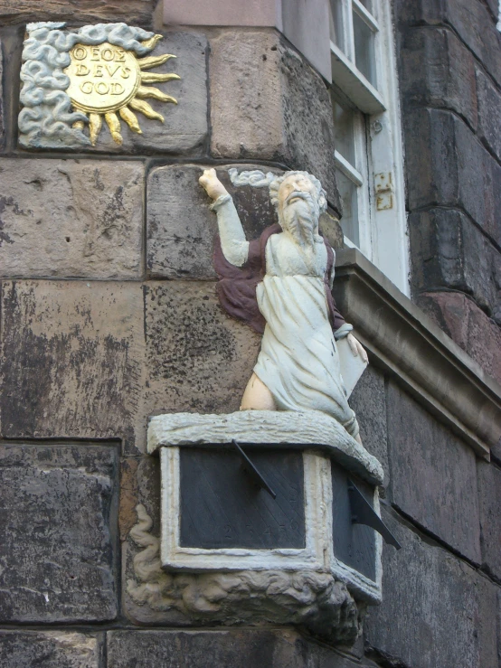 a statue sitting on top of a brick building