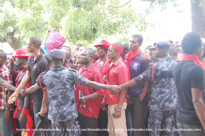 a group of men in red and black shirts