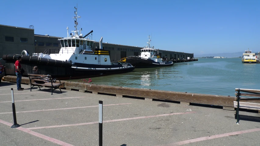 some small boats are tied to a pier