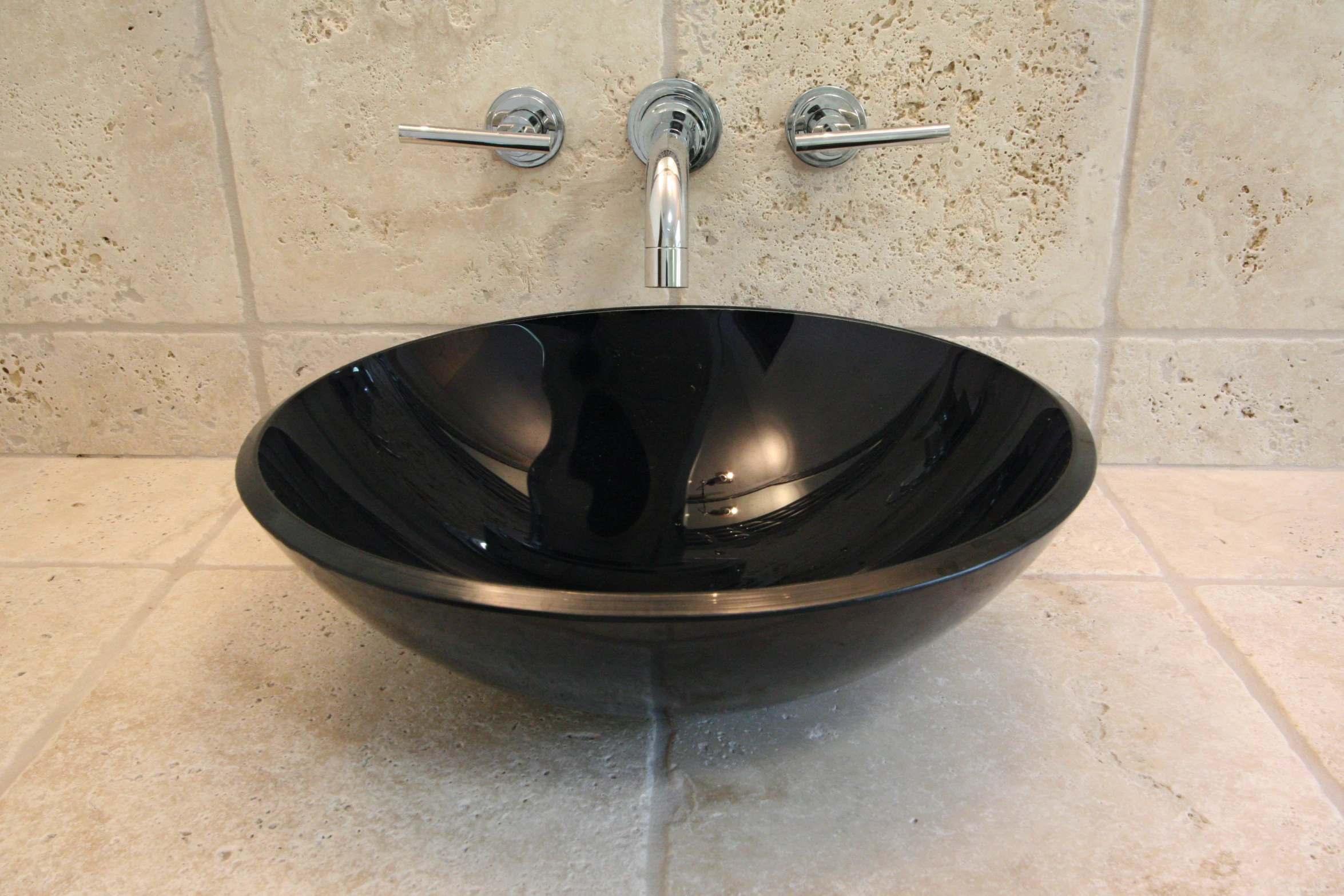 there is a bowl shaped sink with the faucet turned backwards