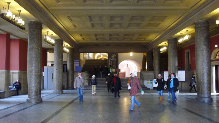 a group of people are walking through an old building