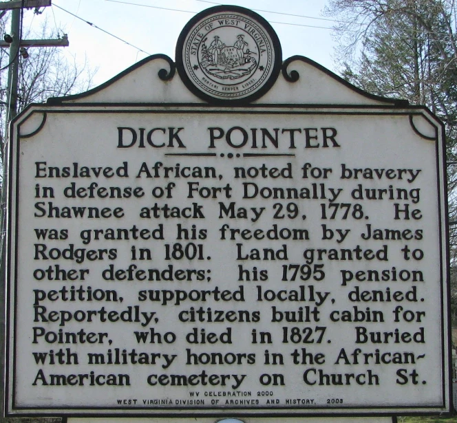 a sign in front of a tall power line