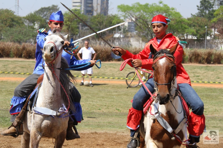 two people in knight suits are sitting on horses