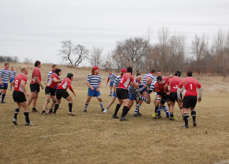 a rugby game in progress with several players standing on the field