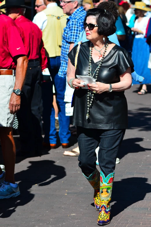 a person in a black leather jacket with colored boots