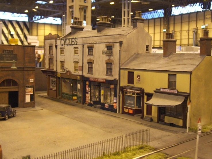 toy model store with buildings on the side of a train track