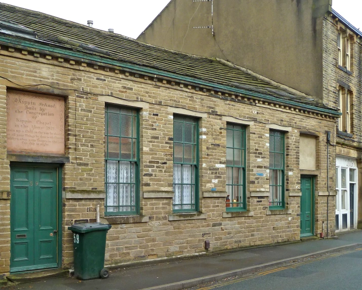 a brick building is shown on a city street