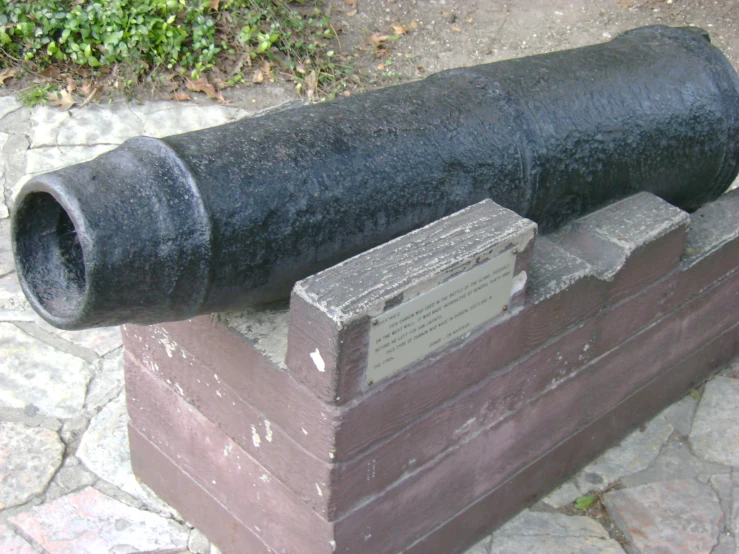 an old cannon sits on top of wooden crates