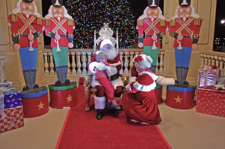 a santa clause kneeling in front of three other santas