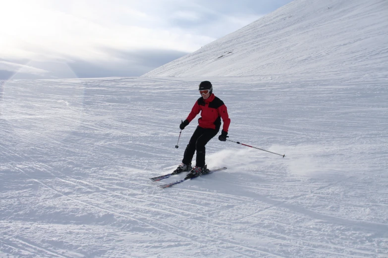 the man is skiing down the hill on the slope