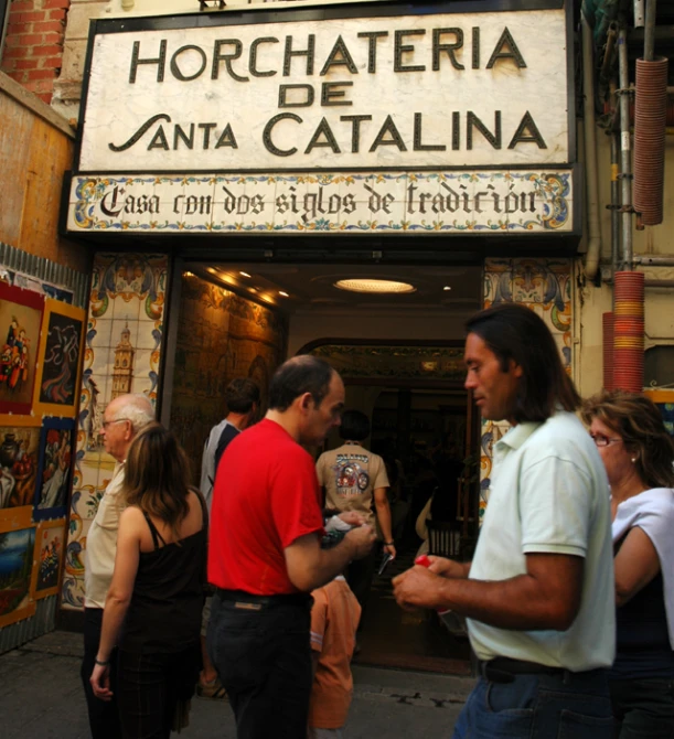 a group of people that are standing outside of a building