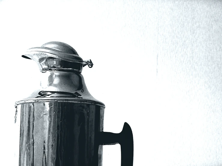 an old fashioned steel coffee pot on a shelf