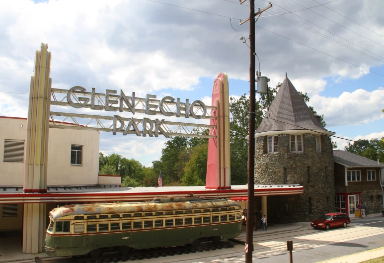 a train sits outside a large church with a clock on it