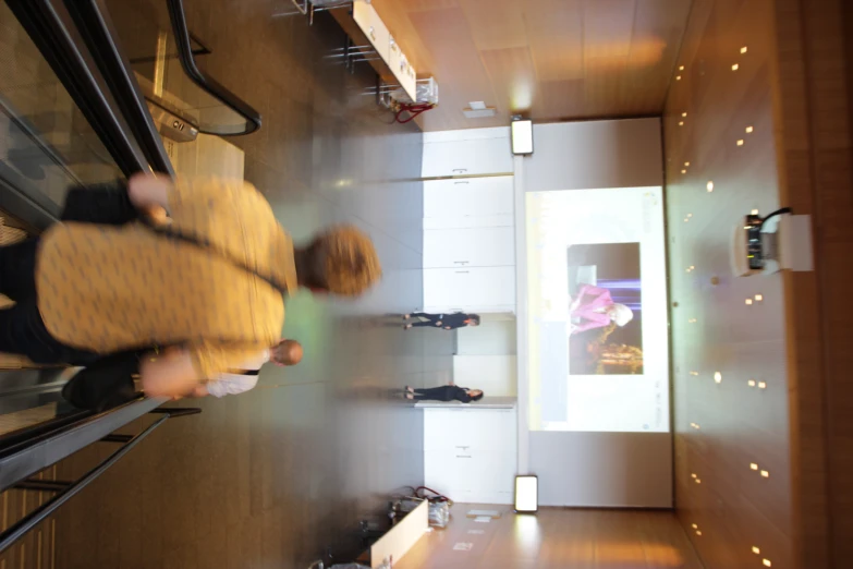 men walking up and down escalators in a building