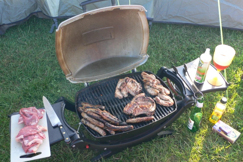 a grill has various kinds of meats on it