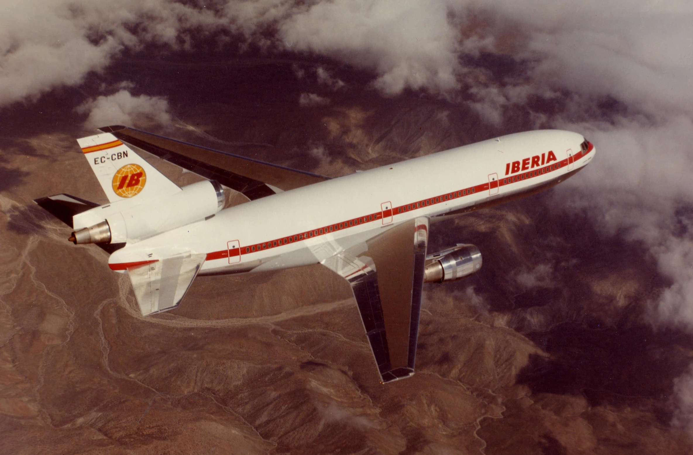 a jumbo jet flying above a vast area of clouds