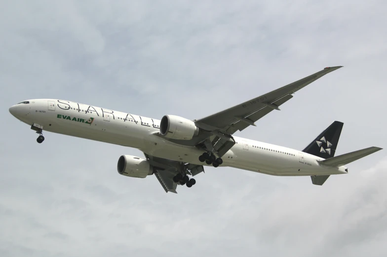 a plane is flying in the sky with a cloudy background