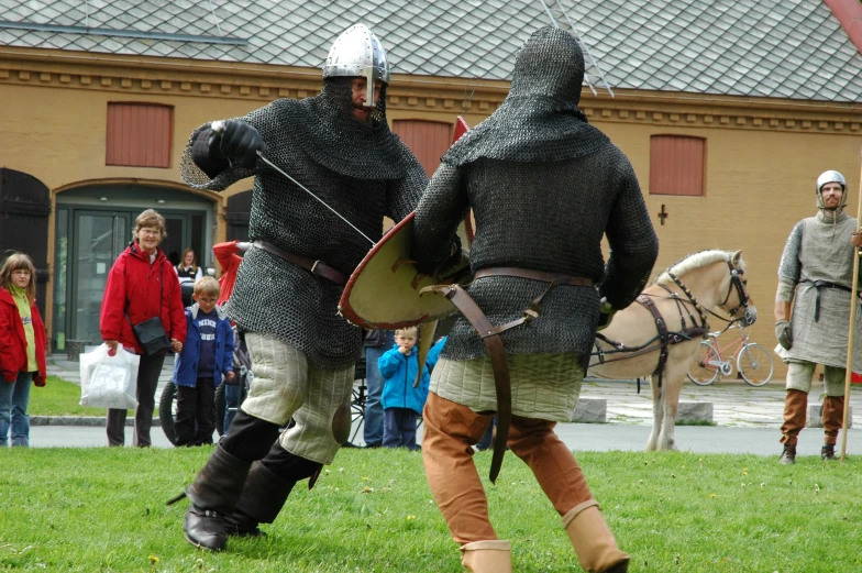 two knights with shield and spears standing next to each other
