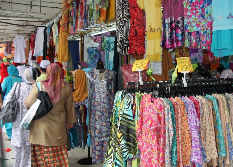 a clothing store with woman shopping at the street